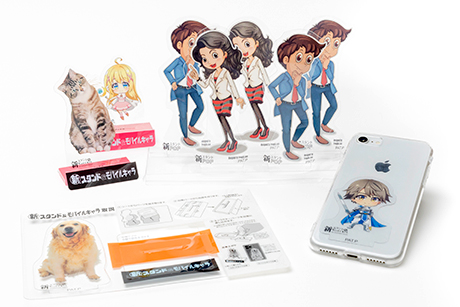 【SPツールコンテスト大賞】 出展社名    （株）シルキー・アクト 商品名    「新スタンド＆モバイルキャラ」略称「スタモバ」 商品の特徴    推しキャラをスマホに挟んで持ち歩き、立てても飾れる新感覚グッズ